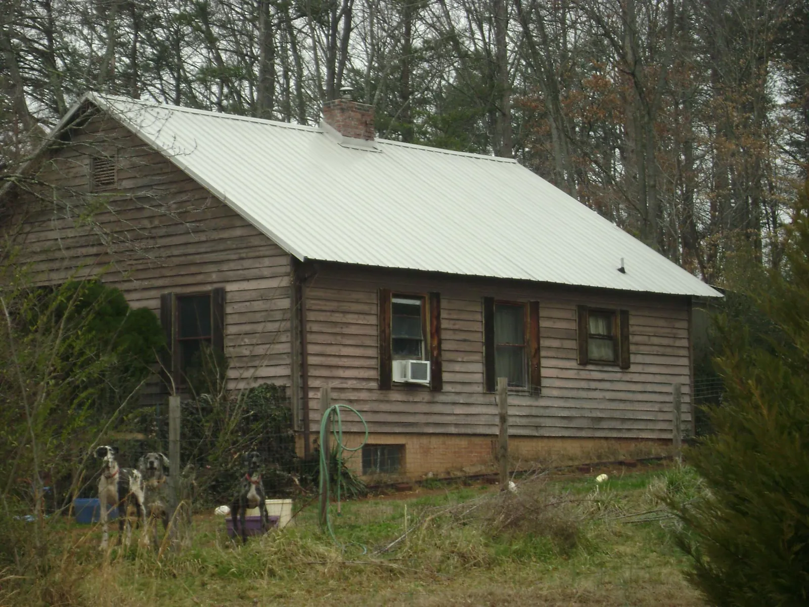 White metal roof on an old wood sided farmhouse, from a Metal Roof Installation job in Connersville